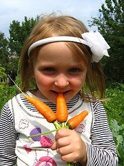 Image showing Girl biting the carrot