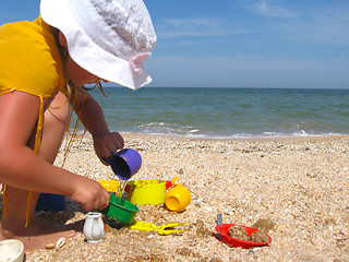 Image showing little girl plays at the sea