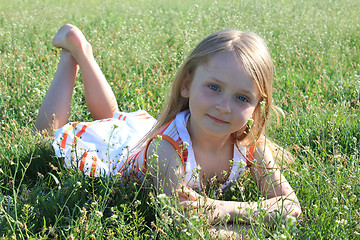 Image showing portrait of little girl lying on the grass