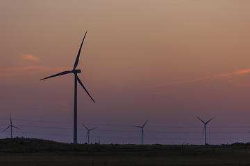 Image showing Windmills silhouettes at sunrise