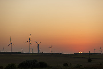 Image showing Windmills silhouettes at sunrise