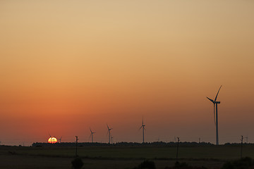 Image showing Windmills silhouettes at sunrise