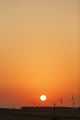 Image showing Windmills silhouettes at sunrise