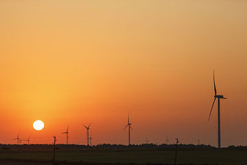 Image showing Windmills silhouettes at sunrise