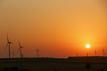 Image showing Windmills silhouettes at sunrise