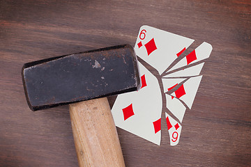 Image showing Hammer with a broken card, six of diamonds