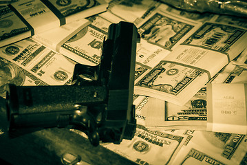 Image showing gun and money