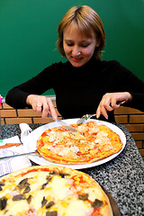 Image showing portrait of sympathetic young woman in pizzeria