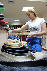 Image showing young woman chooses shoe in shoe shop