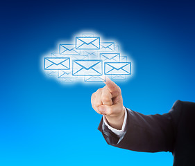 Image showing Corporate Arm Reaching Into Cloud Swarm Of Emails