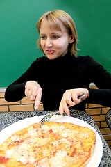 Image showing portrait of sympathetic young woman in pizzeria