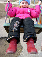 Image showing little girl plays on the swing