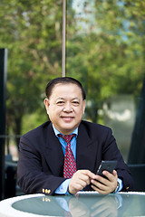 Image showing Asian businessman using smart phone