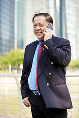 Image showing Asian businessman talking on smart phone