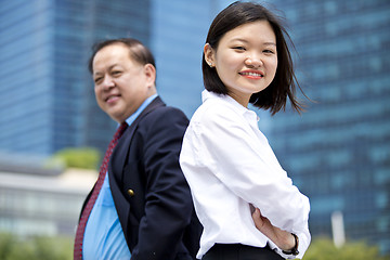 Image showing Asian businessman and young female executive smiling portrait