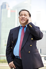 Image showing Asian businessman talking on smart phone