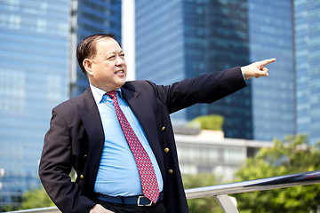 Image showing Asian businessman pointing at a direction