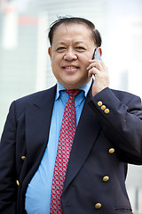 Image showing Asian businessman talking on smart phone