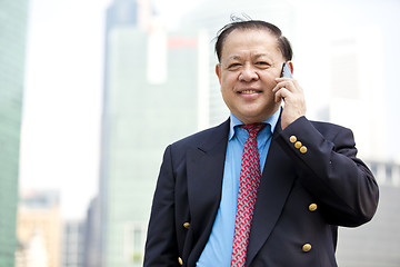 Image showing Asian businessman talking on smart phone