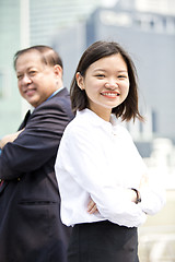 Image showing Asian businessman and young female executive smiling portrait