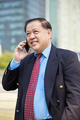 Image showing Asian businessman talking on smart phone