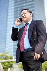 Image showing Asian businessman talking on smart phone