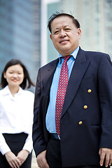 Image showing Asian businessman and young female executive smiling portrait