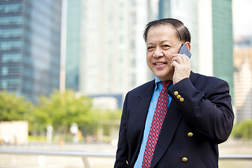 Image showing Asian businessman talking on smart phone