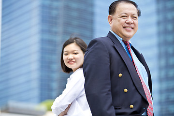 Image showing Asian businessman and young female executive smiling portrait