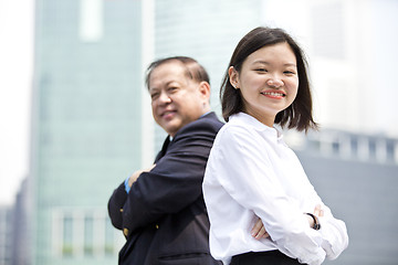 Image showing Asian businessman & young female executive smiling portrait