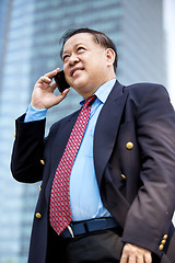 Image showing Asian businessman talking on smart phone