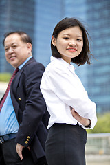 Image showing Asian businessman & young female executive smiling portrait