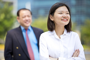 Image showing Asian businessman & young female executive smiling portrait