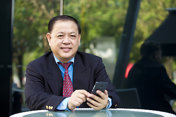 Image showing Asian businessman using smart phone