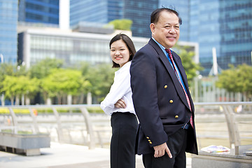 Image showing Asian businessman & young female executive smiling portrait