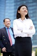 Image showing Asian businessman & young female executive smiling portrait