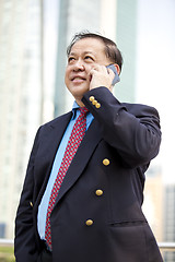 Image showing Asian businessman talking on smart phone