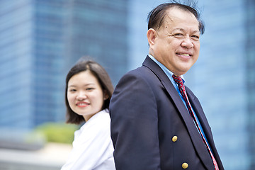 Image showing Asian businessman & young female executive smiling portrait