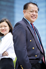 Image showing Asian businessman and young female executive smiling portrait