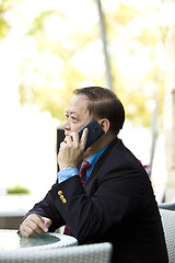 Image showing Asian businessman talking on smart phone