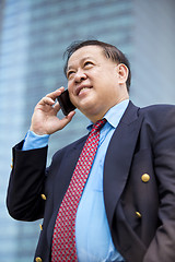 Image showing Asian businessman talking on smart phone