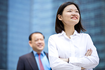 Image showing Asian businessman and young female executive smiling portrait