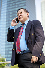 Image showing Asian businessman talking on smart phone