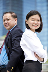 Image showing Asian businessman and young female executive smiling portrait