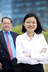 Image showing Asian businessman and young female executive smiling portrait