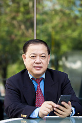 Image showing Asian businessman using smart phone