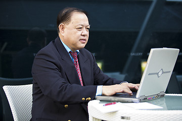 Image showing Asian businessman using laptop