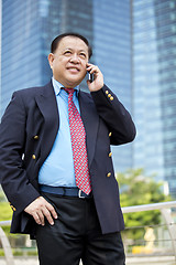 Image showing Asian businessman talking on smart phone