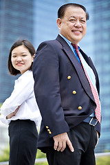 Image showing Asian businessman and young female executive smiling portrait