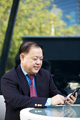 Image showing Asian businessman using smart phone